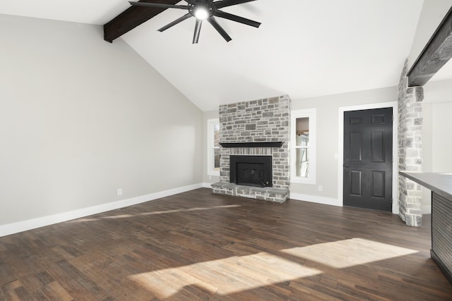 unfurnished living room featuring a fireplace, dark hardwood / wood-style flooring, lofted ceiling with beams, and ceiling fan