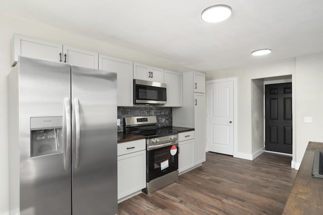 kitchen featuring appliances with stainless steel finishes, dark hardwood / wood-style flooring, white cabinetry, and backsplash