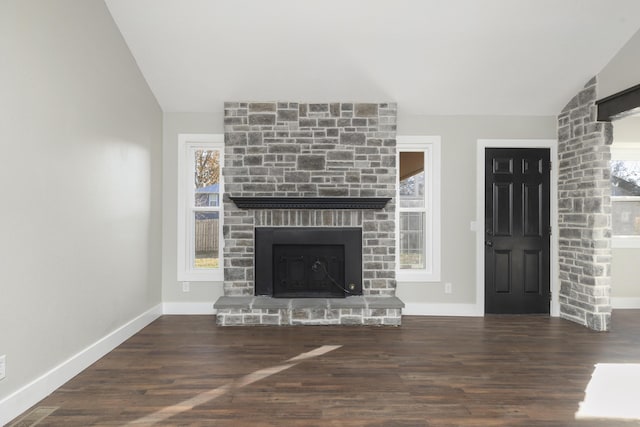 unfurnished living room with a fireplace, dark wood-type flooring, and vaulted ceiling