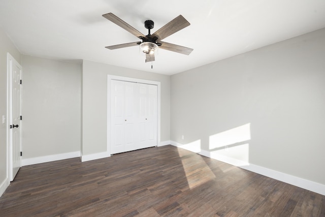 unfurnished bedroom featuring ceiling fan, dark hardwood / wood-style flooring, and a closet