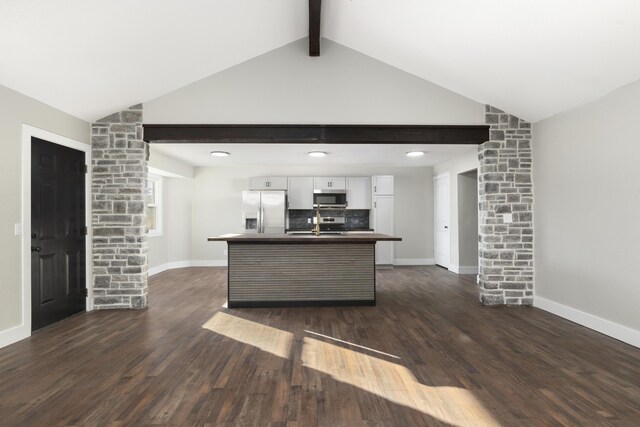 kitchen with dark hardwood / wood-style floors, lofted ceiling with beams, white cabinetry, and appliances with stainless steel finishes