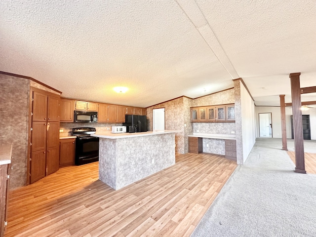 kitchen with a textured ceiling, light wood-type flooring, lofted ceiling, and black appliances