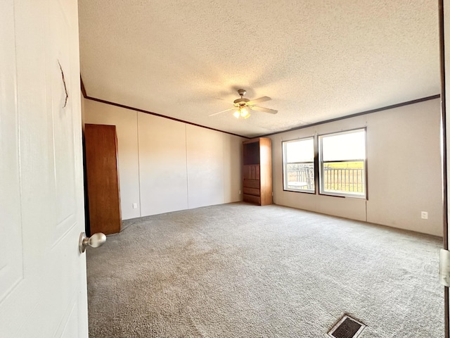 unfurnished room featuring carpet flooring, a textured ceiling, and ceiling fan