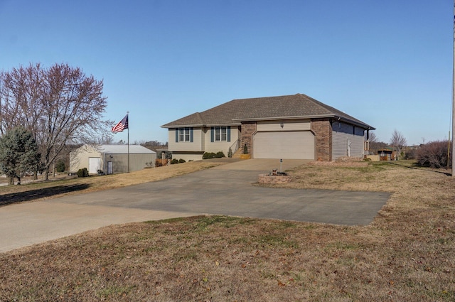 view of front of home with a front lawn and a garage