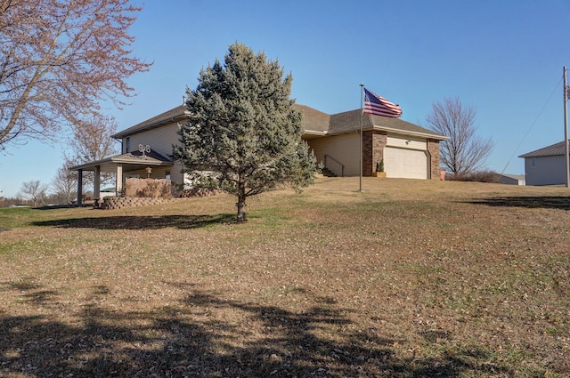 exterior space featuring a garage and a front yard