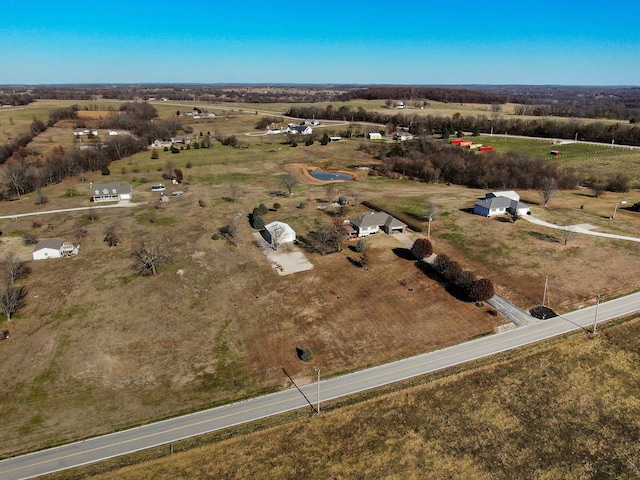 birds eye view of property with a rural view