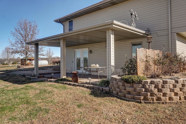 exterior space featuring a lawn and french doors