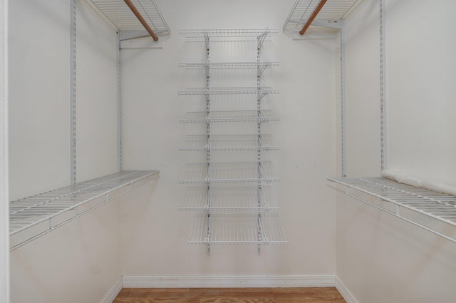 spacious closet featuring light hardwood / wood-style floors