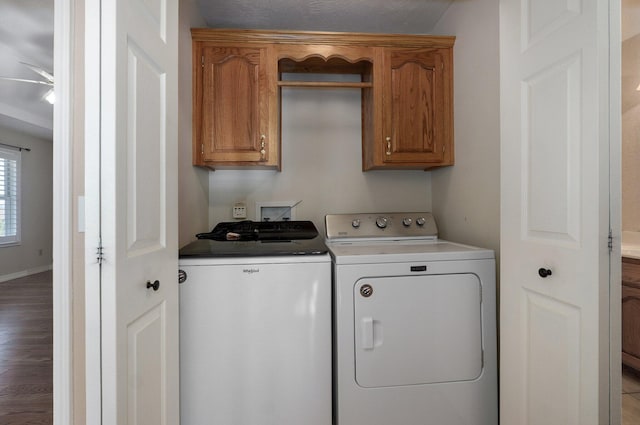 washroom with ceiling fan, cabinets, hardwood / wood-style floors, a textured ceiling, and washer and clothes dryer