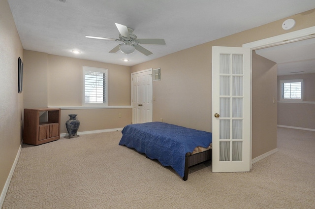 bedroom featuring ceiling fan and light colored carpet