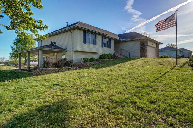 10071 W Farm Road 48, Walnut Grove, MO 65770 - rear view of property featuring an attached garage and a yard