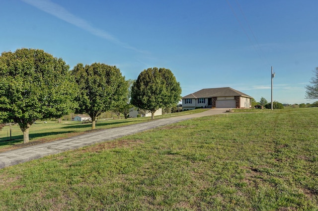10071 W Farm Road 48, Walnut Grove, MO 65770 - view of front of home featuring driveway, a garage, and a front lawn