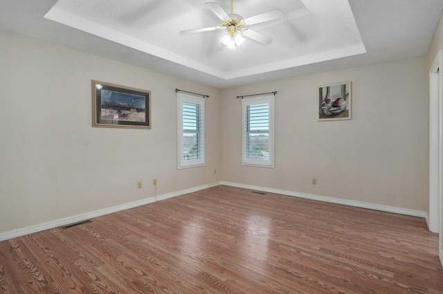 10071 W Farm Road 48, Walnut Grove, MO 65770 - unfurnished room with a tray ceiling, wood finished floors, ceiling fan, and baseboards