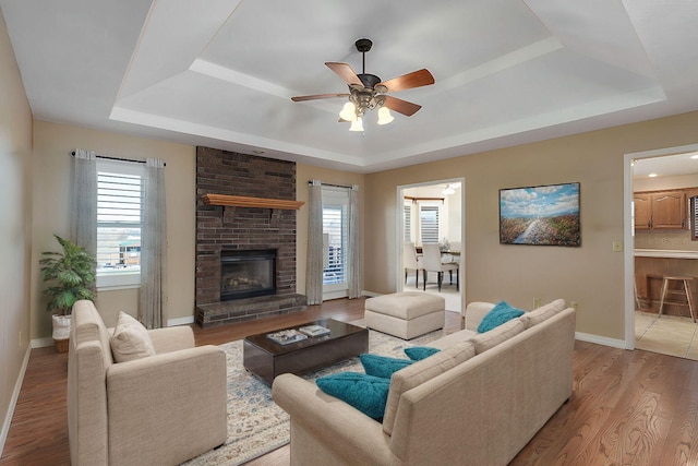 10071 W Farm Road 48, Walnut Grove, MO 65770 - living area with a raised ceiling, ceiling fan, baseboards, and light wood-style flooring