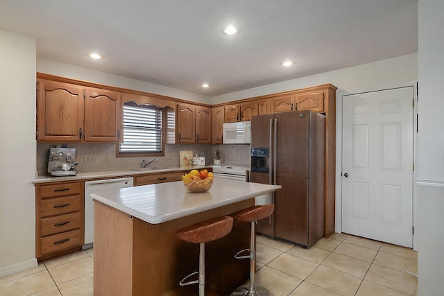 10071 W Farm Road 48, Walnut Grove, MO 65770 - kitchen featuring white appliances, light tile patterned floors, light countertops, backsplash, and a kitchen island