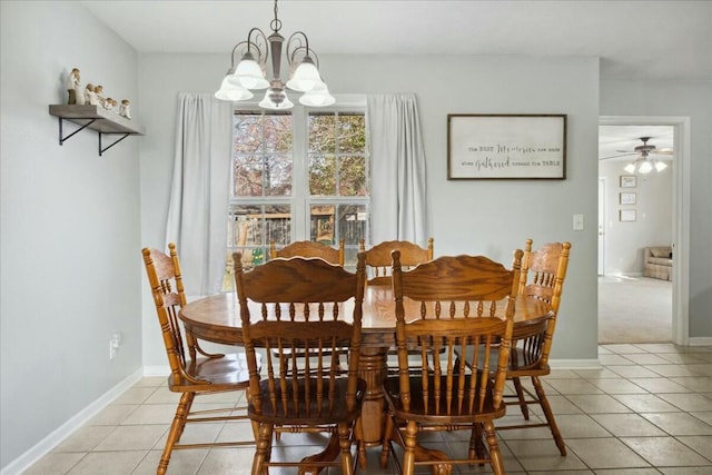 tiled dining space featuring ceiling fan with notable chandelier