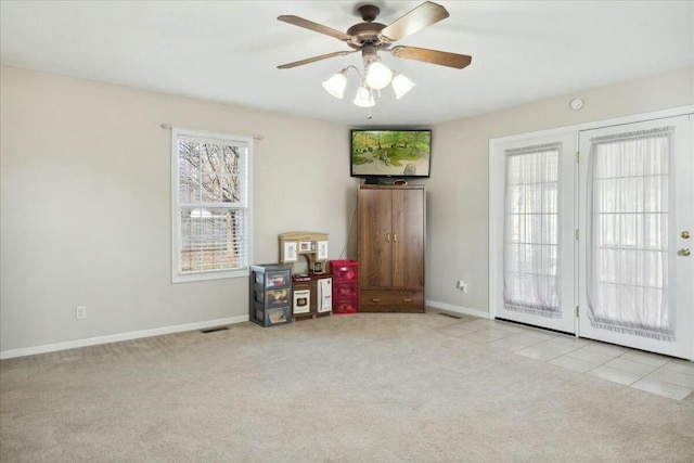 misc room with light colored carpet and ceiling fan