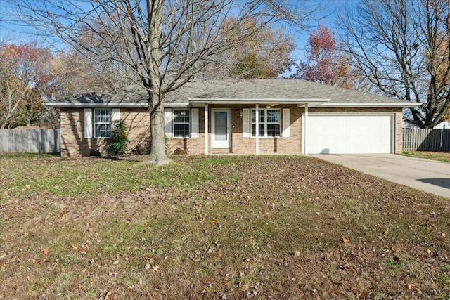 ranch-style house with a garage and a front lawn