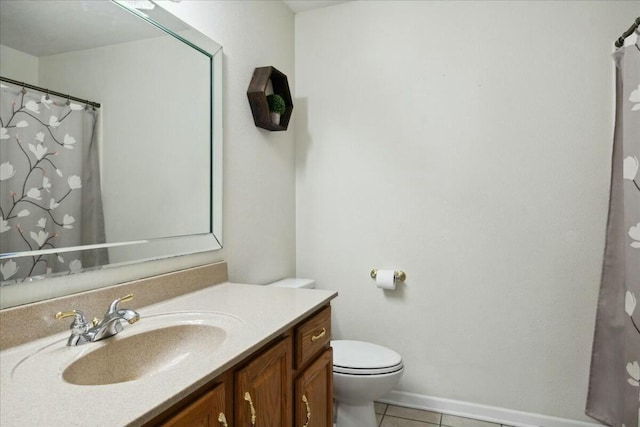 bathroom featuring toilet, vanity, and tile patterned floors