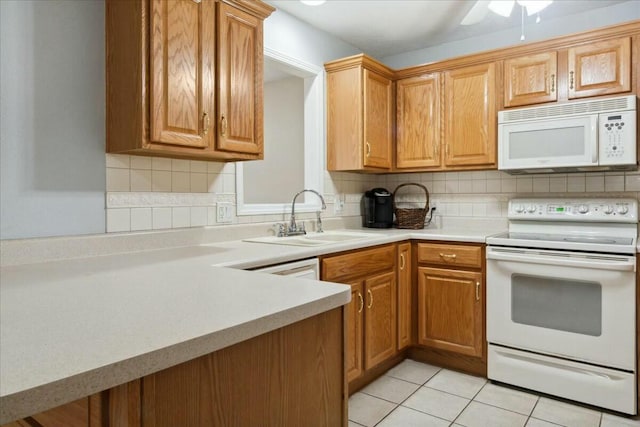 kitchen featuring decorative backsplash, white appliances, sink, and light tile patterned floors