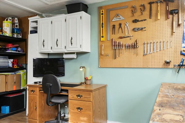 office with a workshop area and hardwood / wood-style flooring