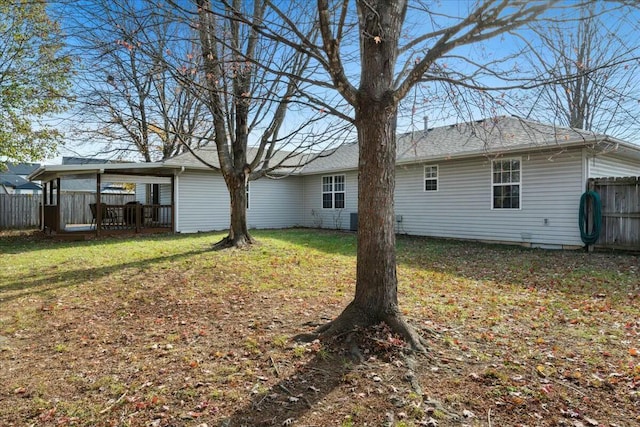 back of house with a lawn