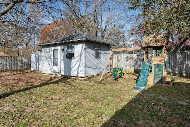 view of outdoor structure with a playground and a yard