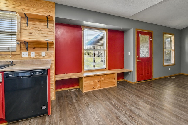 kitchen with dishwasher, dark wood-type flooring, a textured ceiling, and sink