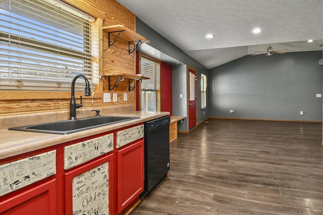 kitchen with vaulted ceiling, ceiling fan, dark wood-type flooring, sink, and black dishwasher