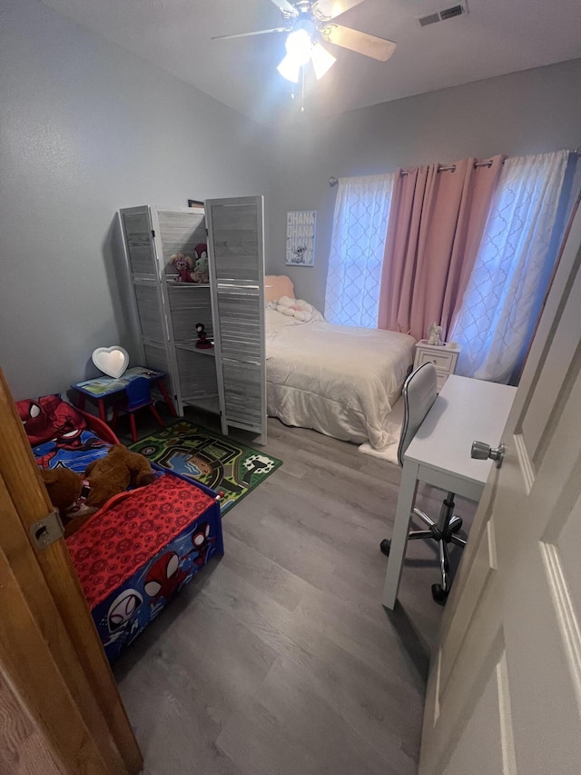 bedroom with wood-type flooring and ceiling fan