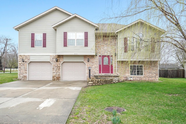 split foyer home with a front yard and a garage