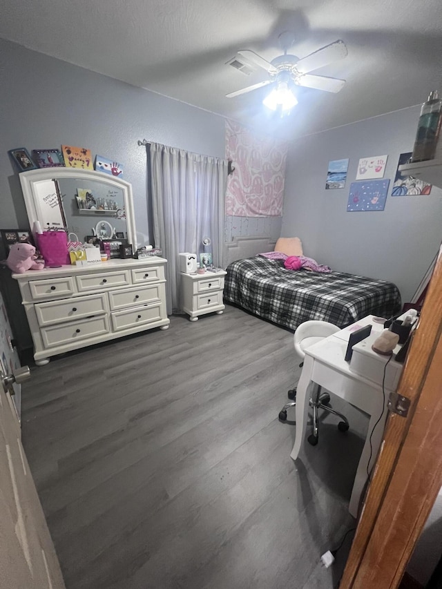 bedroom with ceiling fan and wood-type flooring