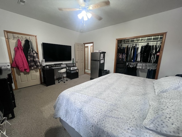 bedroom featuring carpet flooring, a closet, ceiling fan, and refrigerator