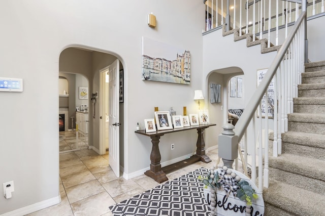 foyer with a high ceiling and tile patterned floors