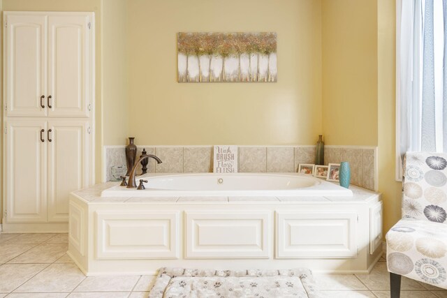 bathroom with tile patterned floors and a bathtub