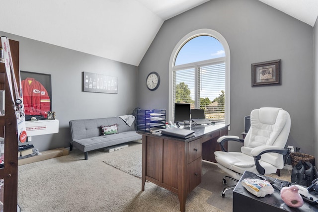 carpeted office featuring vaulted ceiling