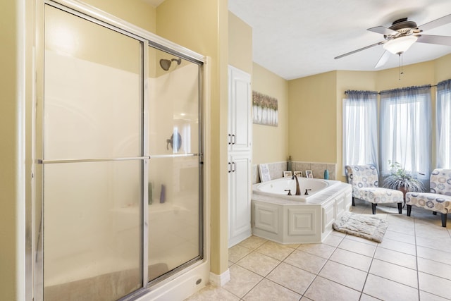 bathroom with tile patterned flooring, ceiling fan, and plus walk in shower