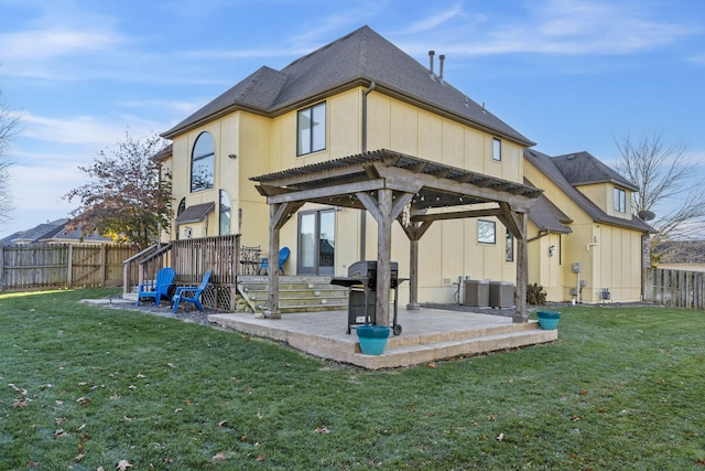 back of house featuring a yard, a patio, and central AC unit