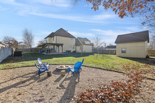 view of yard with a patio, a fire pit, and a storage shed