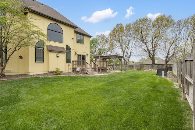 view of yard with a fenced backyard and a deck