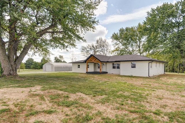 view of front facade with an outbuilding and a front yard