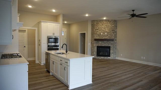 kitchen featuring a center island with sink, white cabinets, sink, dark hardwood / wood-style floors, and stainless steel appliances