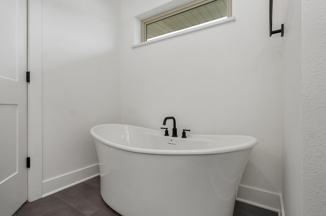 2423 E Cardinal St, Springfield, MO 65804 - full bathroom featuring tile patterned floors, a freestanding bath, and baseboards