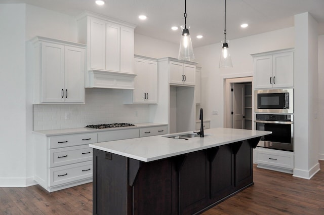 2423 E Cardinal St, Springfield, MO 65804 - kitchen with white cabinets, decorative backsplash, appliances with stainless steel finishes, and dark wood-style floors