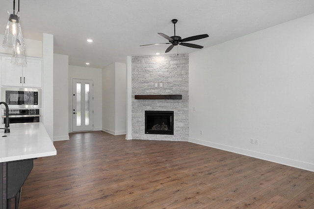 2423 E Cardinal St, Springfield, MO 65804 - unfurnished living room featuring a ceiling fan, dark wood finished floors, and recessed lighting