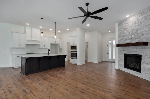 2423 E Cardinal St, Springfield, MO 65804 - kitchen featuring ceiling fan, white cabinetry, light countertops, stainless steel appliances, and open floor plan