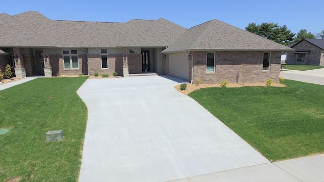 2423 E Cardinal St, Springfield, MO 65804 - ranch-style house featuring a garage, a front yard, brick siding, and driveway