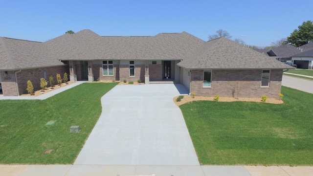 2423 E Cardinal St, Springfield, MO 65804 - ranch-style home with a garage, a front yard, brick siding, a shingled roof, and concrete driveway