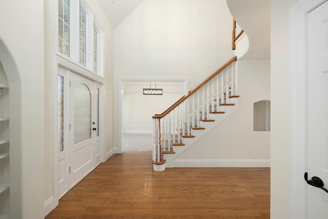 entryway featuring hardwood / wood-style flooring and high vaulted ceiling