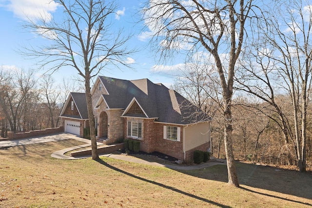 view of front of home with a front lawn and a garage